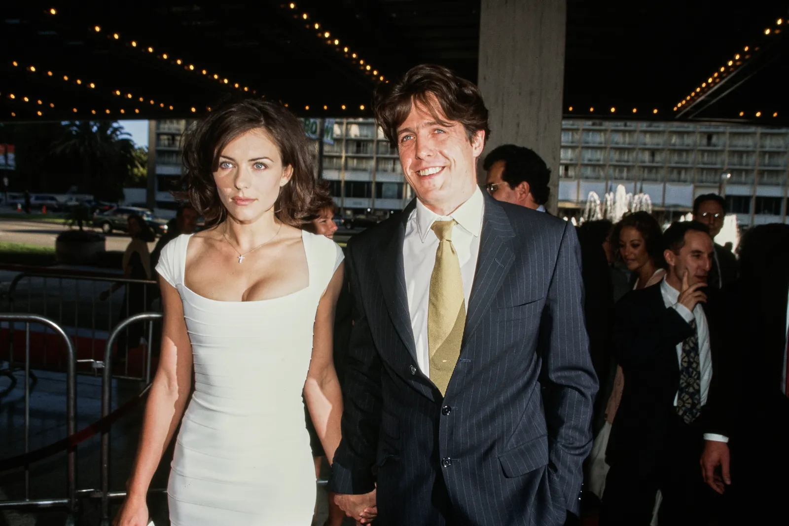 L'image peut contenir Hugh Grant Elizabeth Hurley Peter Chernin Candy Crowley Blazer Vêtements Manteau et veste